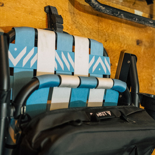 Blue and white striped seat with black bag on a vehicle interior