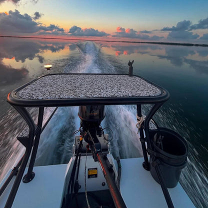 Boat moving on water with a sunset reflection